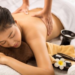 Asian woman having massage and spa salon Beauty treatment concept. She is very happy